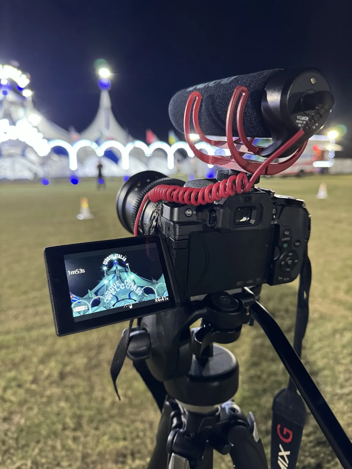 Camera on tripod facing Cirque Italia at night