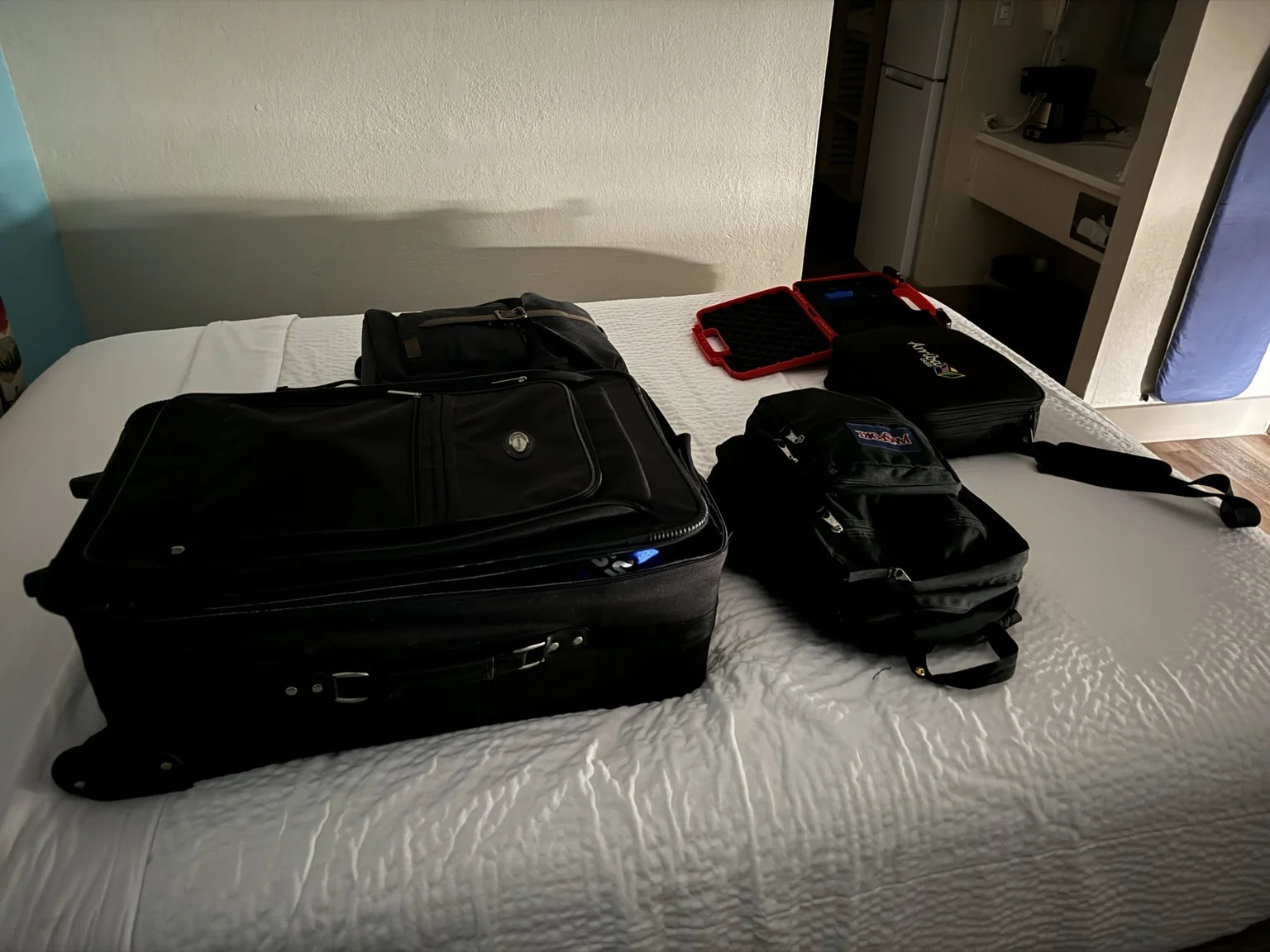 Production gear packed on a hotel bed