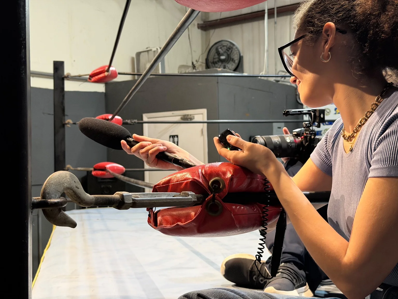 Joselien Vasallo recording production audio at ringside during A Violent Soap Opera