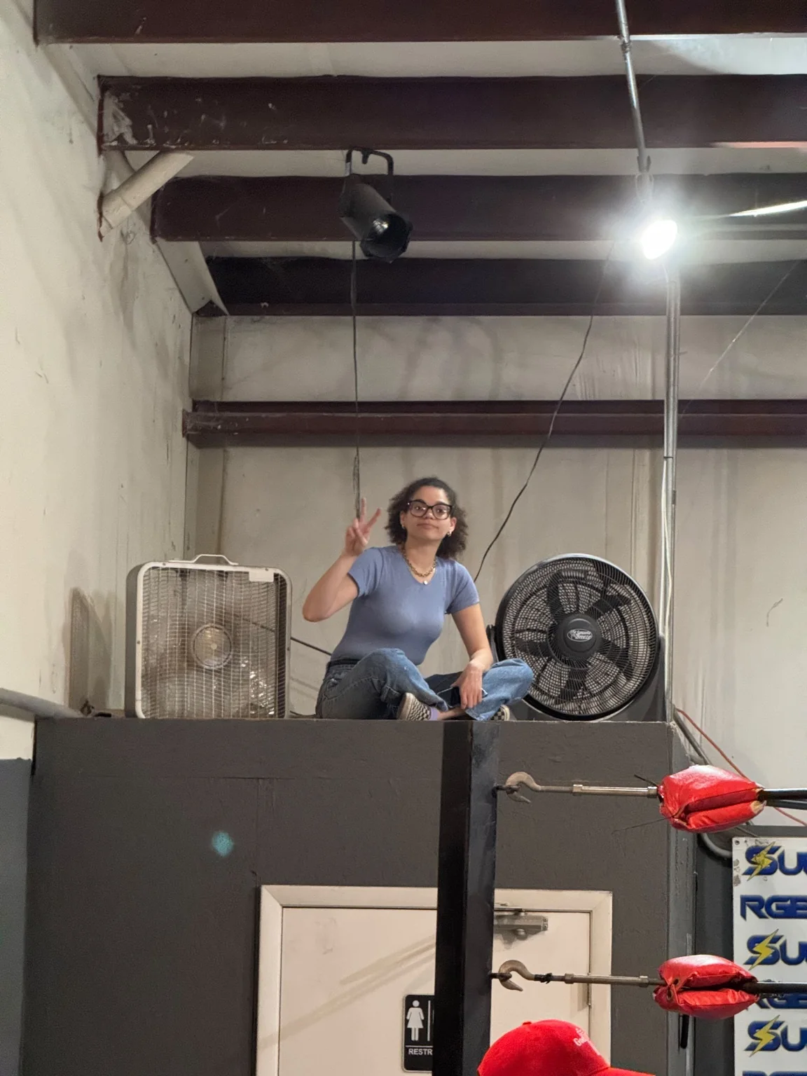 Joselien Vasallo on top of a bathroom to find a camera angle during production of A Violent Soap Opera