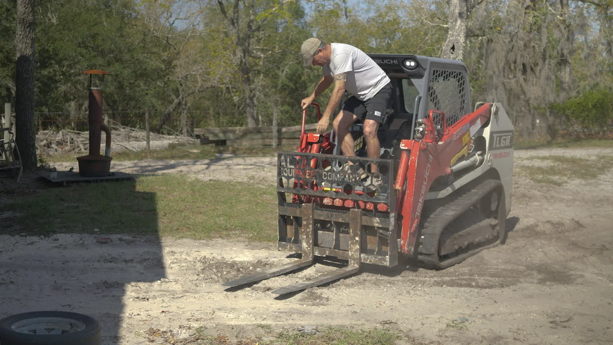 Toby working with a skid steer on his homestead