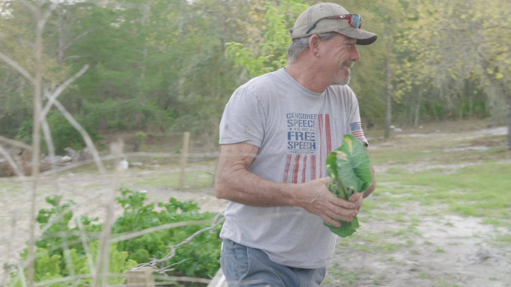 Toby carrying greens on his homestead
